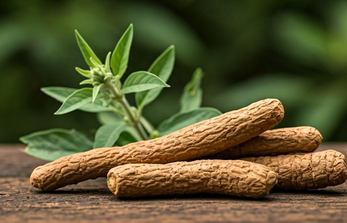 Ashwagandha on a wooden surface with green leaves in the background