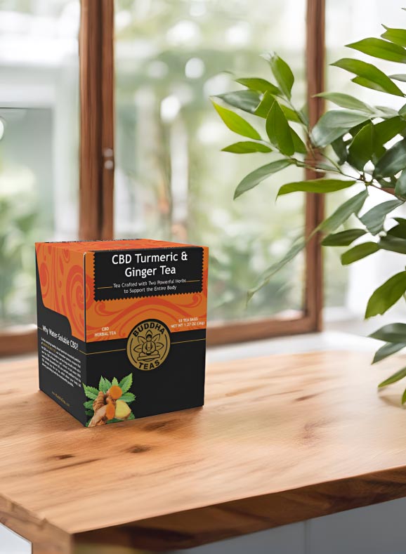 Box of CBD Turmeric & Ginger Tea on a wooden surface with a blurred indoor background