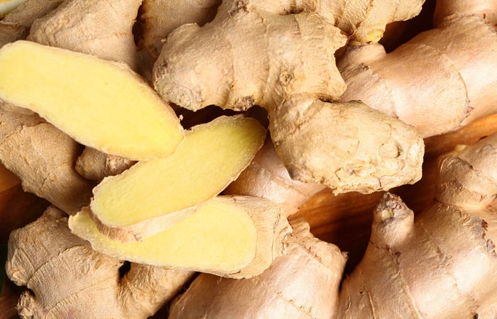 Close-up of ginger roots with a focus on the fresh, yellowish interior.