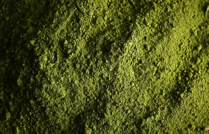 Close-up of matcha green powder with a textured surface