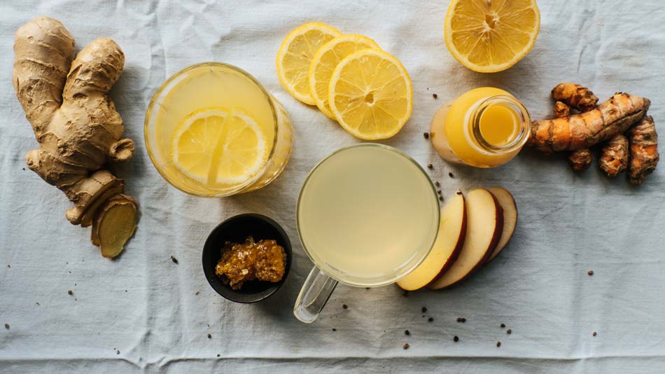 Ginger and lemon juice preparation on a textured surface